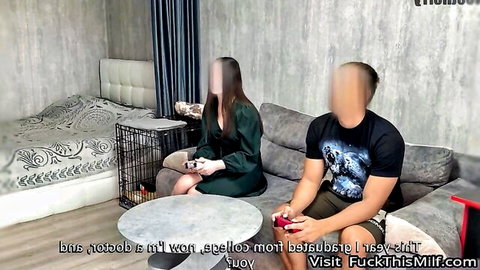 Asian MILF in green dress gaming with man on couch, raunchy couple thumbnail