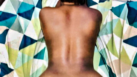 Nude ebony woman back view in reverse cowgirl pose
