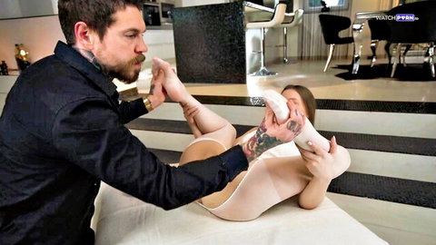 Mia Split in feet seduction, man kissing her stockinged feet in intimate pose
