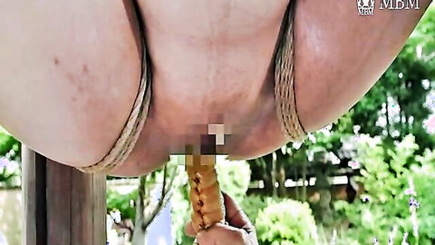 Suspended Japanese widow in outdoor bondage with exposed ass and censored pussy