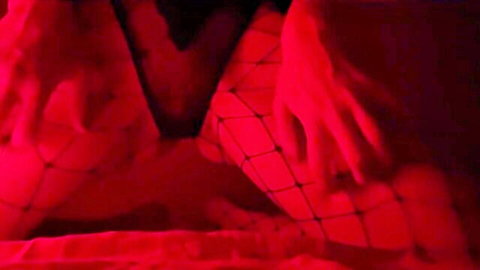 Cutie in red fishnet tights fingers pussy to shaking orgasm