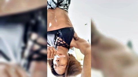 Ebony woman with glasses exposes breasts outdoors, cum on body