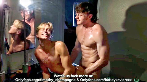 Timothy Champagne and Harley Xavier muscular gay duo embracing intimately over counter