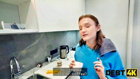 Gorgeous redhead Nashidni in blue hoodie offering tea or coffee, natural tits tease