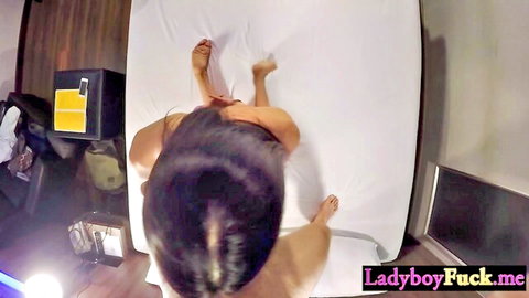 Submissive Asian ladyboy Sugas nude on bed, top-down view