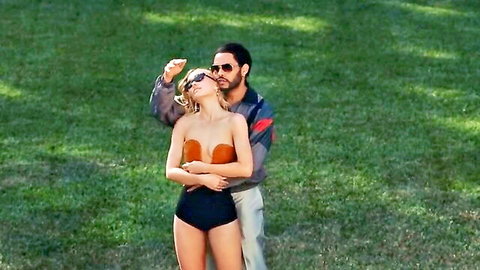 Lily-Rose Depp in orange bikini top and shorts with male partner outdoors, The Idol s01e03