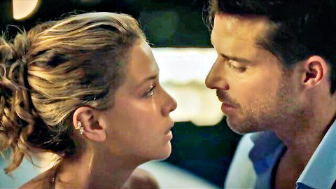 Blonde woman with ponytail stares intimately nose-to-nose at handsome man in blue shirt