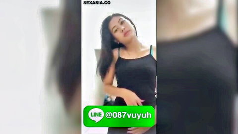 Sexy Thai amateur in tight black tank top turns head seductively teasing viewers