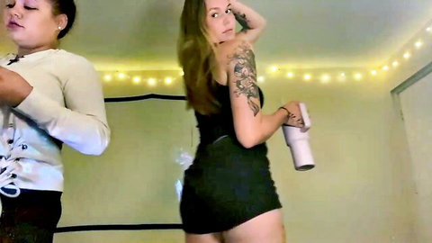 Brookieboooo tattooed camgirl in short black dress posing with ebony friend