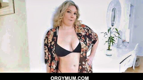 Kiki Daire blonde MILF in open floral kimono and black bra, seductive pose