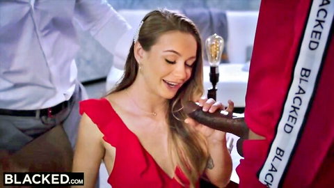 Blonde intern in red dress smiling while gripping big black cock