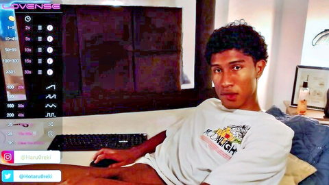 Curly-haired Asian teen lounging in white t-shirt during amateur gay stream