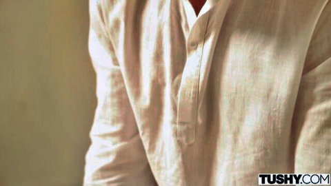 Muscular man unbuttoning open beige shirt exposing hairy toned chest in Tushy porn.