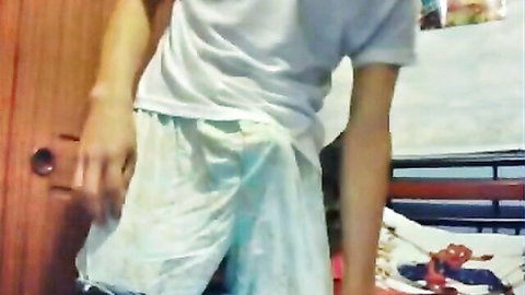 Young Latino guy with hand down loose shorts, teasing bulge
