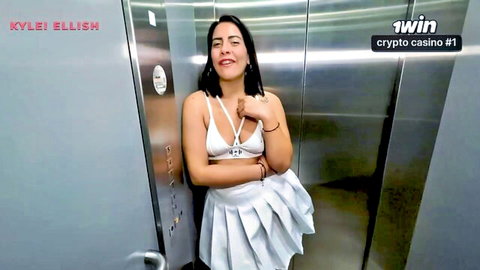 Kylie Ellish in sexy white halter top and skirt in elevator