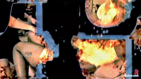 Curvy tanned tattooed babe spreads legs in tight black outfit amid glitchy fire effects