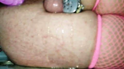 Close-up of curvy woman in pink fishnets climaxing with toys and fluids
