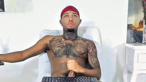 Tattooed black guy strokes his thick cock on webcam while shirtless