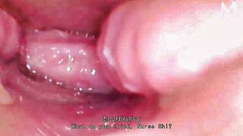 Close-up of wet pink pussy lips spread open in nurse fetish exam