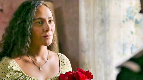 Curly-haired beauty with medium tits in low-cut yellow polka-dot dress holding red roses
