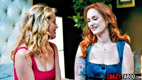 Blonde and redhead MILF chatting intimately in cleavage-baring tops