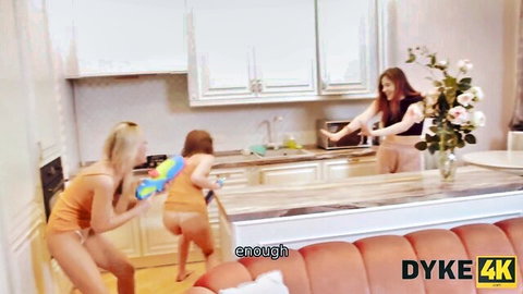 Blonde and redhead lesbians in playful kitchen water fight, DYKE4K