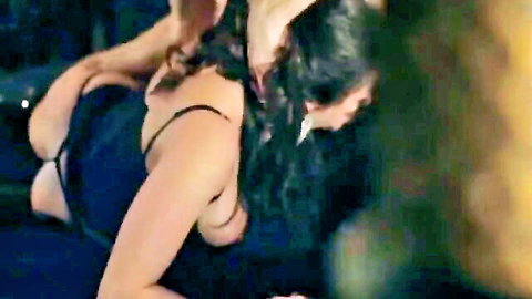 Two sexy women in lingerie embracing passionately in dark scene
