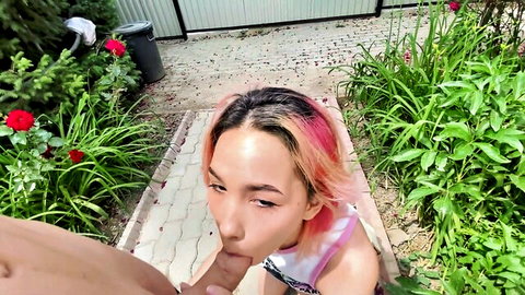 Pink-haired Asian woman giving outdoor blowjob to stranger for cash