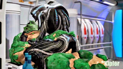 Mr. Kipler animated alien embracing busty green-skinned female in sci-fi pose