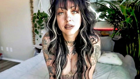 Tattooed alt babe with big pierced tits kneeling topless on bed