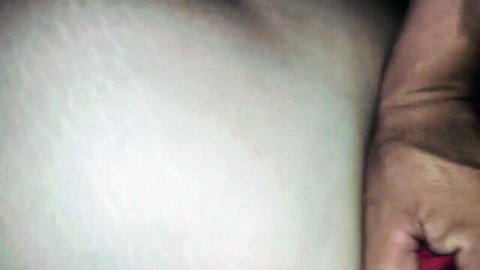 Close-up of pale-skinned woman groped by partner's hand, amateur intimacy
