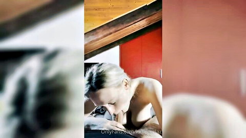 Blonde woman topless performing oral sex on partner