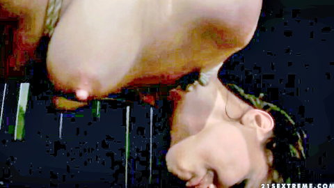 Andy Brown topless in upside-down fetish bondage with exposed breasts