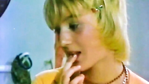 Vintage blonde teasing with finger on lips in yellow top, classic anal porn thumbnail