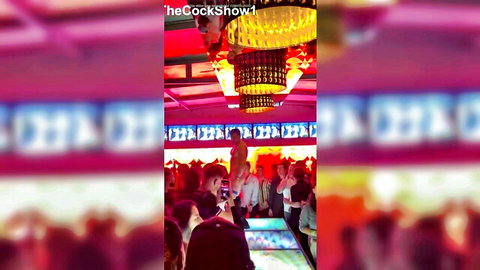 Muscular male stripper performing on stage at crowded cock show