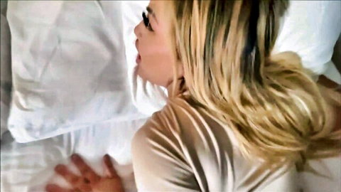 Blonde stepsis lying in bed with open mouth, teasing vacation denial scene