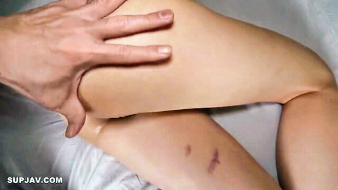Man's hand spreads woman's thigh exposing wet pink pussy on bed
