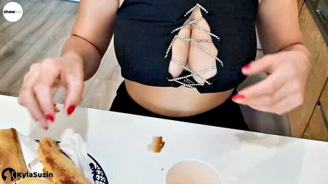 KylaSuzin teases massive cleavage in black lace top while eating kebab