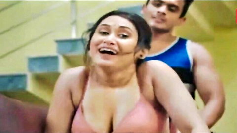 Curvy Indian woman in pink lingerie embraced by muscular man from behind