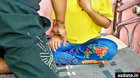 Desi Indian babe in yellow top gets pussy rubbed through blue jeans by guy on bed