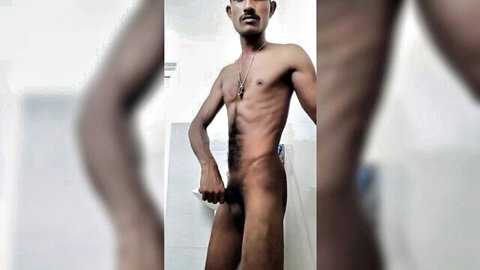 Slim hairy South Asian man stroking erect cock in bathroom