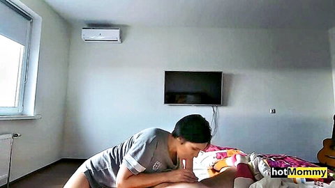 Hot stepmom in gray top and shorts enjoys stepson's intimate oral on bed
