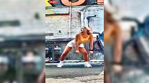 Blonde e-girl with big tits squats teasingly legs spread in tight white shorts orange crop top urban dance