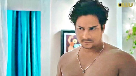 Sexy shirtless Indian man with curly hair and necklace, intense gaze