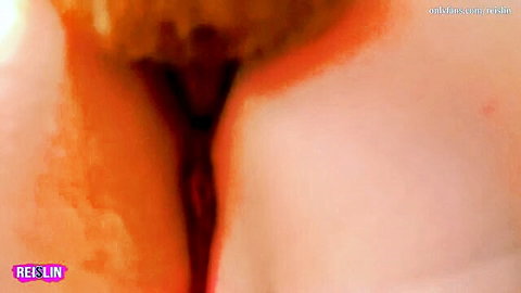 Closeup of wet pink pussy spread wide open with glistening labia majora and minora
