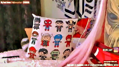 Zero Two cosplay in superhero-themed bedroom setup