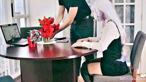 Asian girl with long white hair sits at desk receiving red poinsettia flowers from man behind her