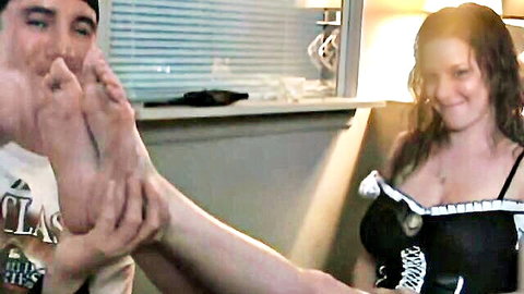 Woman in black lingerie worshipping man's foot in intimate scene