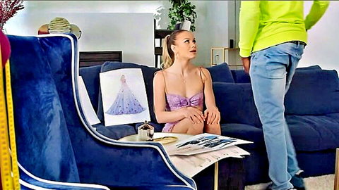 Surprised young blonde in purple bra sits legs together on blue couch as man in neon green hoodie stands behind her