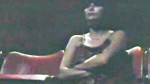 Vintage woman in dark slip sitting pensively on chair